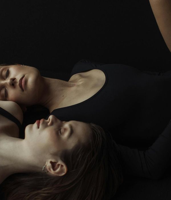 Woman performing a gentle yoga pose in a calm, modern studio.